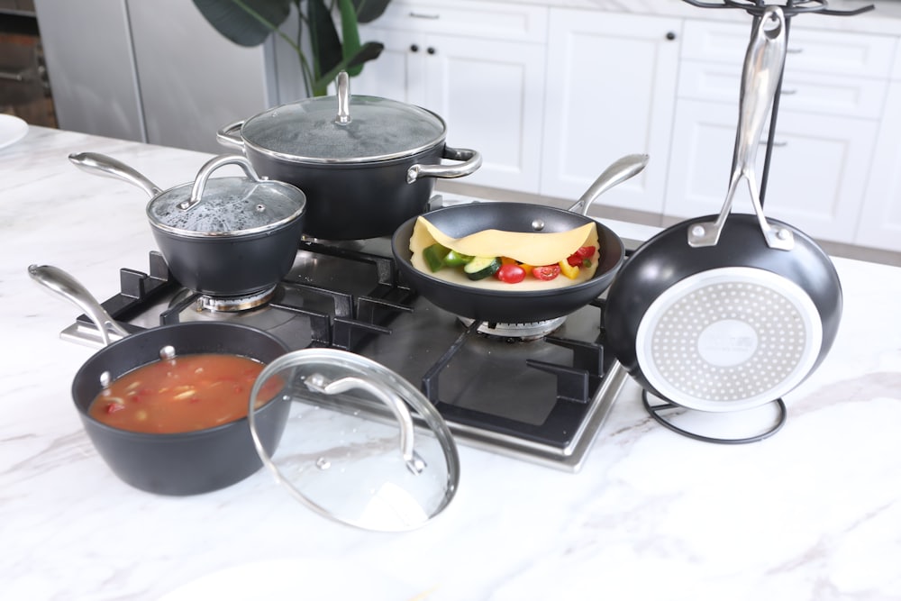 Stainless steel cookware being tested on a stovetop