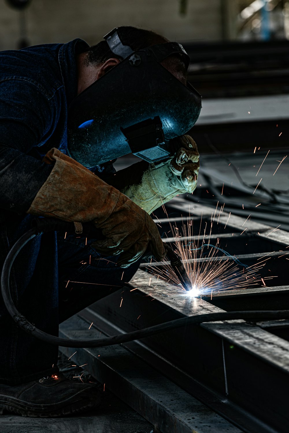 Metalworker welding steel components